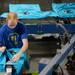 Underground Printing press assistant Keith Erts removes a t-shirt off of the press at the warehouse on Thursday, July 11, 2013. Melanie Maxwell | AnnArbor.com